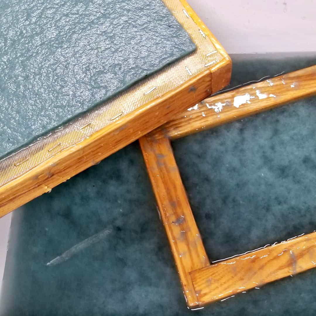 Wooden deckle and wet flax paper during the papermaking process