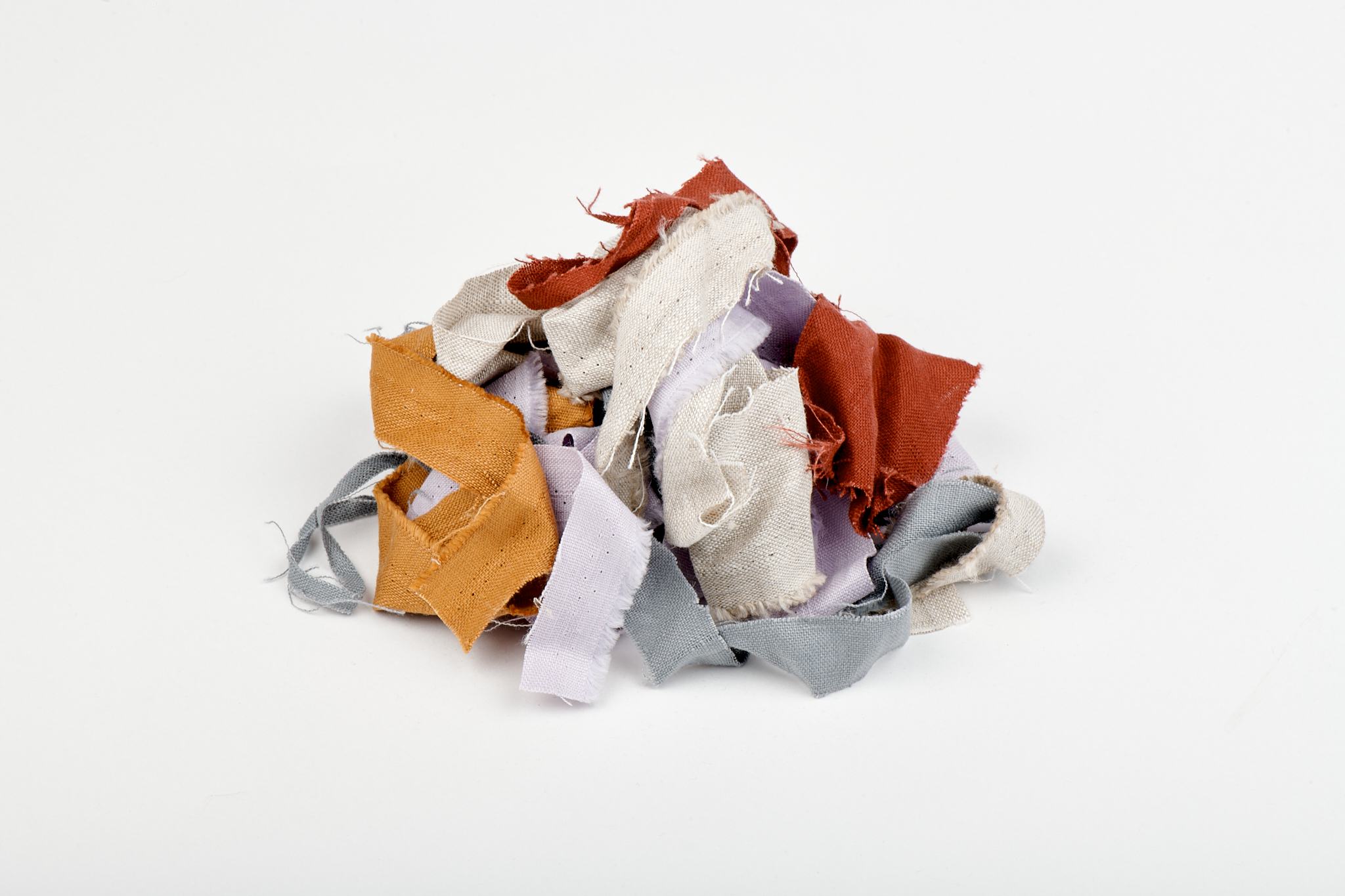 Assorted linen offcuts ready for papermaking